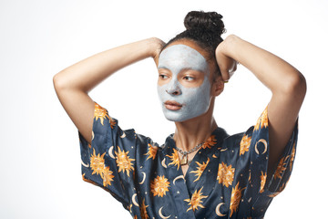 funny yong girl with clay beauty mask on skin isolated model