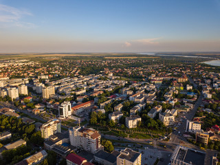 Fototapeta premium Aerial view of Slatina city and river Olt, Romania. Drone flight over the european city in summer day.
