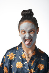 funny yong girl with clay beauty mask on skin isolated model