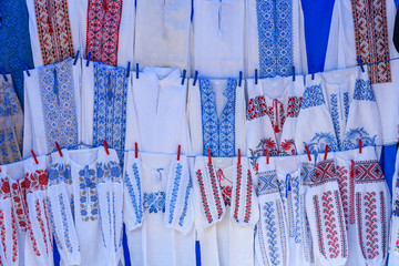 Bright ethnic shirts with traditional Ukrainian embroidery for sale on a street festival