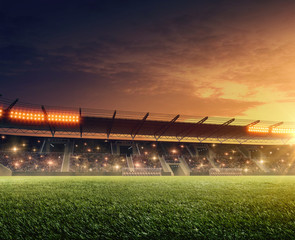 Soccer stadium with illuminated tribunes. Sports event. Night  dramatic sky.