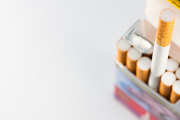 Cigar box isolated on white background. Cigarette taken out of the box. Tobacco can cause diseases in the organism.