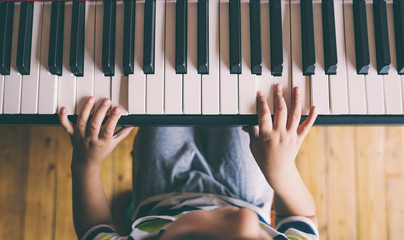 A child learns to play the piano.