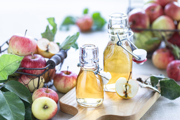 Apple vinegar. Bottle of apple organic vinegar or cider on wooden background. Healthy organic food. With copy space.