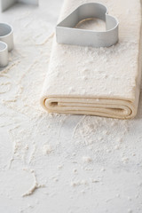 Fresh raw dough on table. Puff pastry. Copy space.