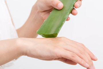 Female hand applying aloe vera gel on a skin. Natural alternative medicine.