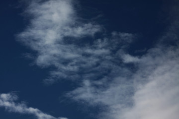 White clouds on dark blue background