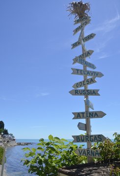 Pointers ''Rome, Paris, New York, Istanbul, Telaviv, Odesa, Russia, Atina, Burgas, Varna" in Bulgarian Nesabar. Blue sky and beautiful black sea.