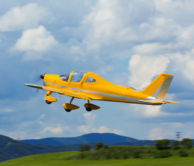 Small sports airplane hovering highly in the sky outdoor