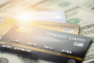 close up and selective focused of credit card on banknote background