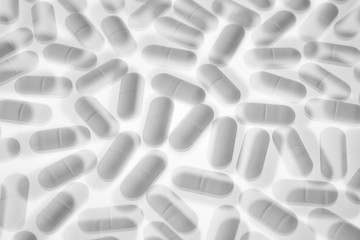 Pills arranged on a white background