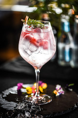 tonic gin with  fresh raspberry and rosemarie plant