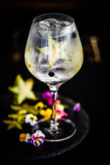 tonic gin cocktail with fresh carambola fruit