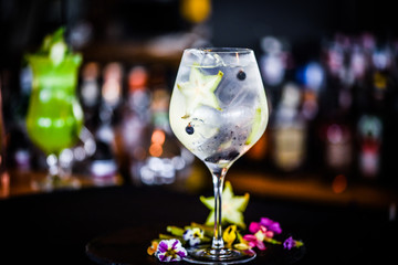 tonic gin cocktail with fresh carambola fruit