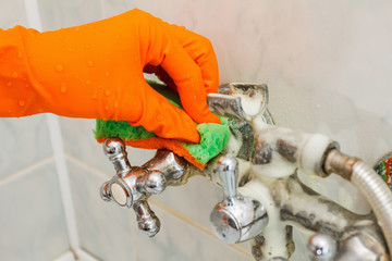 Housemaid cleaning a bathroom, closeup shot