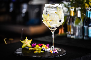 tonic gin cocktail with fresh carambola fruit