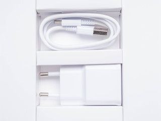 white power ac to dc adapter in white background, charger in white box