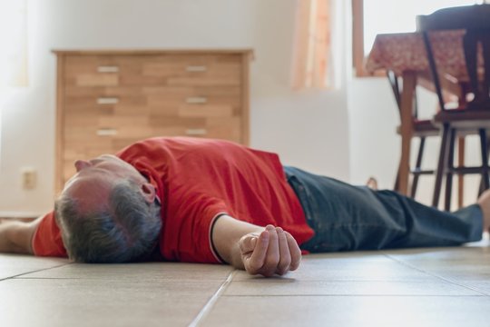 Man lying on the floor at home, epilepsy, unconsciousness, faint, stroke, accident  or other health problem