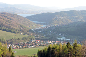 A view of a forest, the Soła river, the Międzybrodzkie lake and a city in the valley in the...