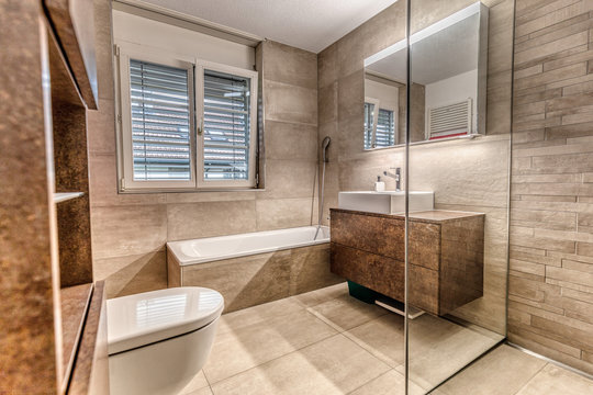 Interior of a modern bathroom with brown furniture