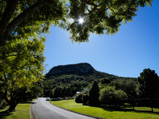 Mount Ninderry with lush green trees against a vivid blue sky,. near Noosa on the Sunshine Coast hinterland, Queensland, Australia
