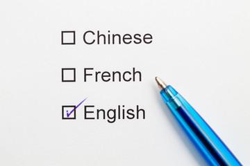Chinese, French, English - checkmark with pen on paper.