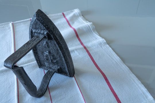 an vintage smoothing ironer object on a table