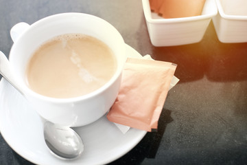 Cup of coffee on black mable table.