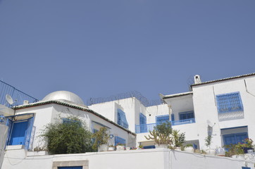 Fototapeta na wymiar Medina. Cityscape with white blue colored houses in resort town Sidi Bou Said. Arabian culture. Tunisia, North Africa. Background.