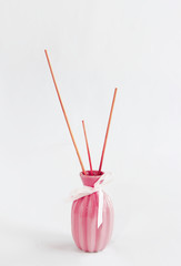 wooden sticks for aromatherapy in a ceramic pink vase