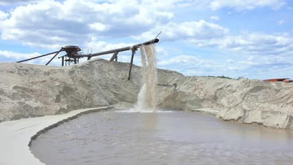 Industrial extraction of sand for construction. From the pipe discarded sand with water under strong pressure.
