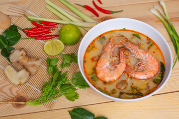 Thai food tom yum koong or spicy shrimp soup in a white bowl