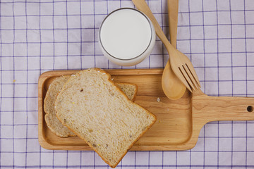 Top view sliced whole wheat bread on wooden plate