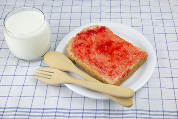 Whole wheat bread with red strawberry jam
