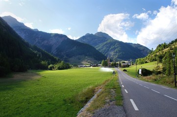 Naklejka premium Mountain pastures in the national parc Queras in French alps, and the village of Arvieux, known to be an historical refuge during religious persecutions