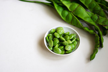 Raw bitter beans or Petai isolated on white background. Selective focus.