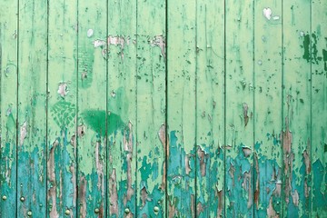 Texture of blue and green paint on wooden wall