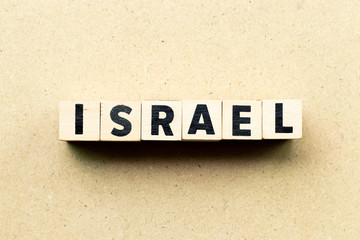 Letter block in word israel on wood background