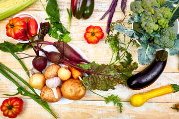 Fresh colorful organic vegetables from above. Top view, flat lay. Different vegetables for eating healthy on wooden background. Clean eating food frame. Copy space. Vegetarian, vegan..