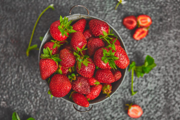 Ripe red strawberries on black table, Strawberries in white bowl. Fresh strawberries. grey strawberries. Diet food. Healthy, vegan. Top view. Flat lay. Copy space.