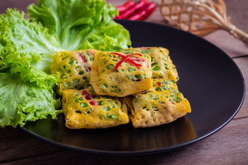 Fried minced pork, prawns, vegetable and nut wrapped in egg net (Latieng), Thai traditional food