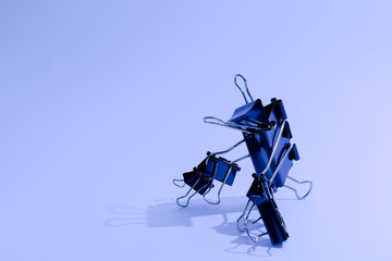 Black binder clip in cool tones