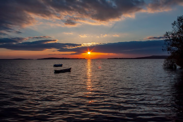 Fototapeta premium Blue fishing boat at sunset on the Black Sea