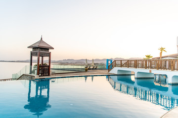 Sharm El Sheikh, Egypt - May 2019: The concept of comfortable rest near the pool. Beautiful swimming pool with a bar in the oriental style.