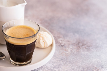 Cup on black coffee with milk and sweets. Good morning and remote work. Copy space.