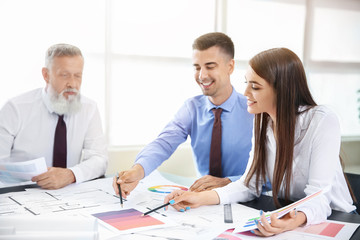 Team of architects discussing project in office