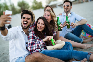 Happy group of young people having fun at beach