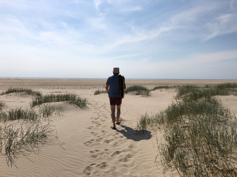 Man walking on beach, Fanoe, Jutland, Denmark