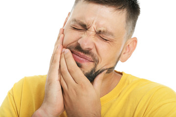 Man suffering from toothache against white background