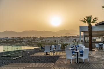 Sharm El Sheikh, Egypt - May, 2019: Beautiful beach with palm trees at sunset
